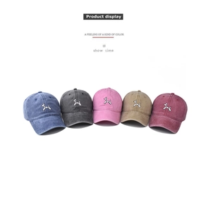 Five washed cotton baseball caps with balloon dog embroidery in various colors