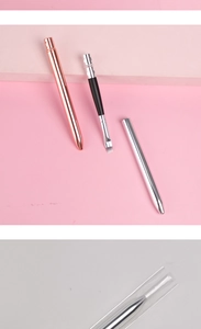 Detailed view of professional metal makeup brushes with rose gold and silver protective caps
