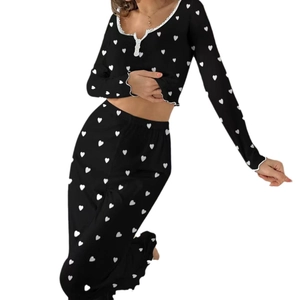 Women black pajama set with white heart print and ruffled trim on ribbed knit fabric