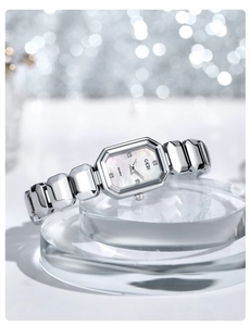 Detail of silver ladies watch with rectangular mother-of-pearl dial and crystal markers