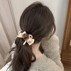Detail of vintage rose fabric hair clip with pearl on model from rear view