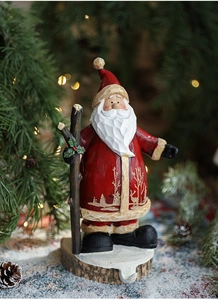 Detail of vintage Santa Claus resin figurine with wood carving texture on snowy base