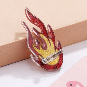 Detailed back view of acrylic flame brooch showing the secure metal safety pin closure