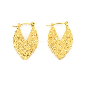 Detailed macro view of 18K gold plated hoop earrings with vintage hammered metal texture
