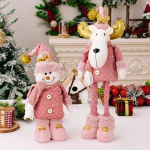 Close-up of pink Christmas plush snowman and reindeer figurines with gold accents