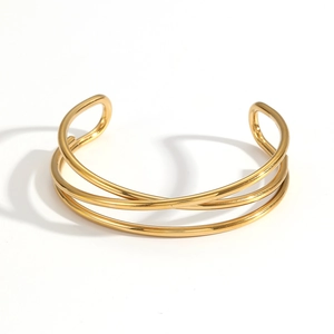 Three-layer crossed coil open bangle in 18k gold plated stainless steel with high polish