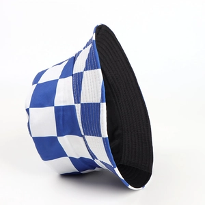 Detail of reversible bucket hat showing blue-white checkerboard print and black lining