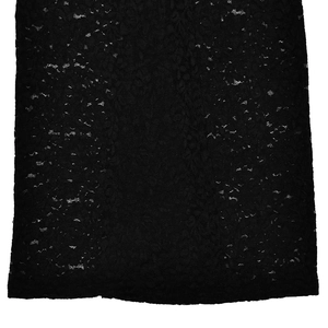 Close-up of black floral lace fabric texture with intricate hollow-out mesh details