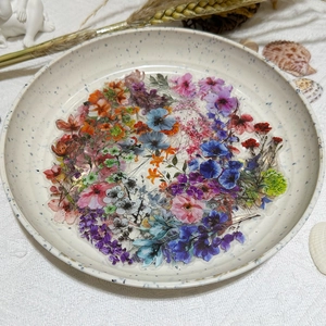 Detailed view of ink-style flower stickers displayed in a ceramic tray for crafts