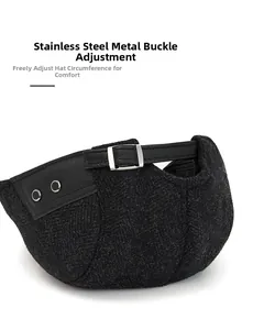 Detail of adjustable stainless steel buckle on black herringbone wool flat cap back