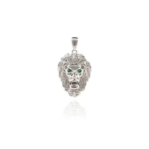 Close-up of a silver lion head pendant with micro-pave cubic zirconia and green gem eyes