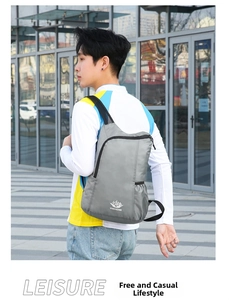 Gray waterproof nylon folding backpack for outdoor hiking shown in an urban setting