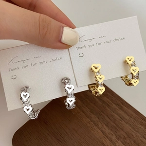 Elegant C-shaped earrings set in silver and gold plating with zircon and heart cutouts