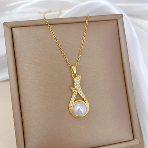 Close-up of pearl pendant necklace with sparkling zircons in a luxury jewelry box
