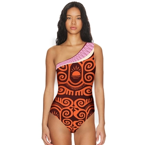 Close-up of one-shoulder swimsuit with tribal orange and brown swirl pattern and ethnic trim