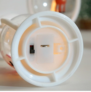 Detail view of the white plastic base featuring a battery compartment and power switch