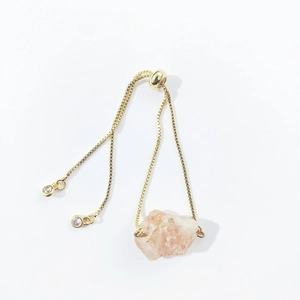 Detail of adjustable gold bracelet with irregular raw natural crystal and slider clasp
