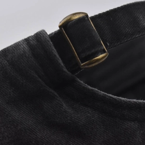 Detail of vintage metal adjustable buckle and black washed cotton fabric on baseball cap