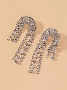 Detailed close-up of sparkling silver rhinestone tassel earrings with a long fringe design