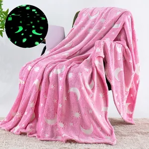 Detail of pink luminous flannel blanket with stars and moon glowing in the dark