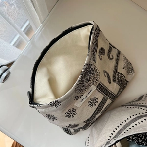 Detail view of cotton linen makeup bag with paisley pattern and simple wish label