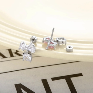 Exquisite bow-shaped geometric earrings with clear and pink zircon stones on silver base