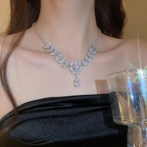 Detail of silver leaf and flower necklace with a large pear-cut zircon pendant