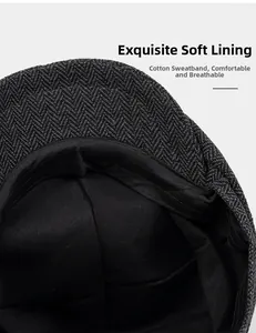 Detail view of the herringbone flat cap showing black lining and cotton sweatband inside