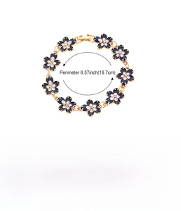 Detail of vintage flower bracelet with blue and white enamel petals and small crystal inlay