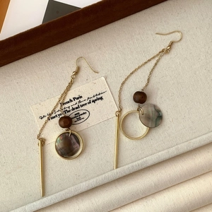 Vintage style long drop earrings featuring wooden beads and iridescent black shells