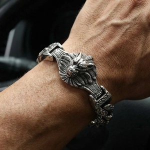 Macro view of detailed lion head engraving on vintage stainless steel men's bracelet
