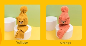 Detailed knit texture of children's fleece-lined bear hat and scarf set in yellow and orange