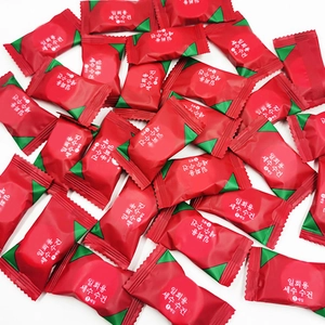 Portable disposable compressed face towels in individual red and green candy packaging