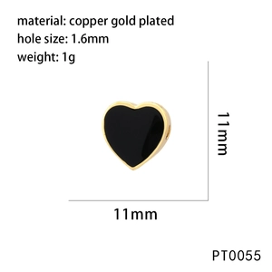 Macro detail of 11mm black enamel heart bead in gold plated copper for jewelry