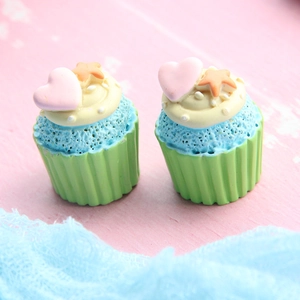 Macro shot of miniature resin cupcakes with blue cake and yellow frosting for DIY crafts