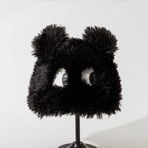Detail showing plush black bucket hat texture with cute cartoon eyes and fuzzy bear ears