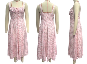 Detail of pink floral midi dress showing ruched bust, bow tie, and slim fit silhouette