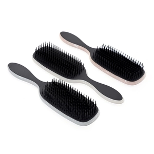 Three professional hair brushes with marble handles and black bristles on white background