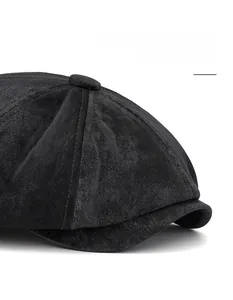 Detail view of the wide brim and matte texture on this vintage black newsboy cap