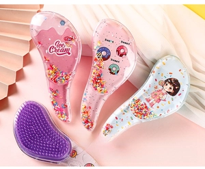 Close-up of cute transparent massage combs with colorful sequins and cartoon patterns