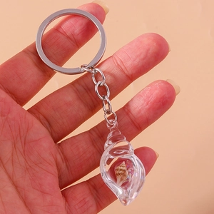 Detailed view of a glowing conch keychain with tiny shell inside for cool style