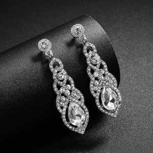 Detail of silver drop earrings with sparkling rhinestones on elegant black jewelry stand