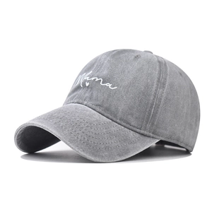 Detail of grey washed cotton baseball cap featuring white Mama script embroidery