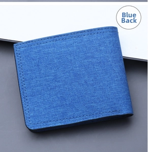 Back view of slim blue canvas bifold wallet for men showing neat black stitching detail
