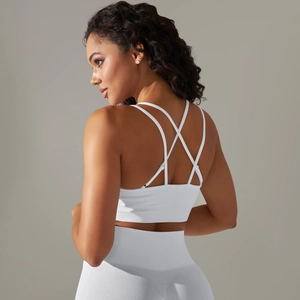 Detailed back view of white seamless sports bra featuring criss-cross strap design