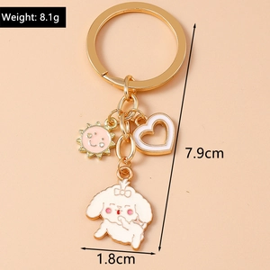 Gold keychain featuring sun, heart and white bichon dog enamel charms with dimensions