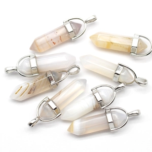 Macro shot of natural crystal and agate hexagonal prism pendants with silver metal clasps