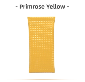 Detail of primrose yellow PU leather pouch with textured micro-prism pattern and metal clasp