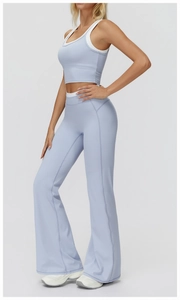 Detail of light blue yoga set featuring a cropped tank top and high-waisted flared pants