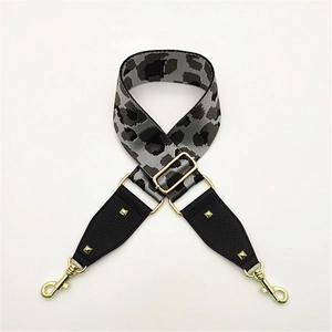 Detailed view of leopard jacquard strap with gold rivets and leather reinforcement